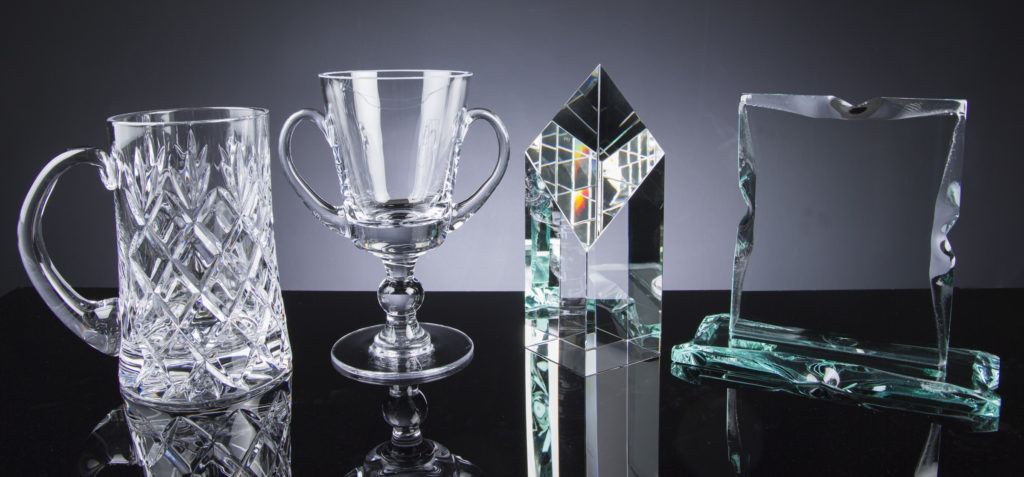 Wholesale Glass and Crystal Supplies at The Glass Scribe. Pictures are a few pieces of our wide range of Items; Inverness Crystal Tankard, Balmoral Glass Loving Cup, WhiteFire Optical Crystal Column and a Portrait Rock Tablet